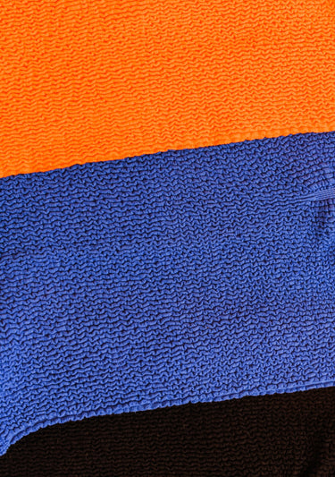 Close up of orange and blue fabric.