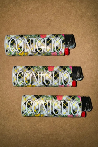 Three Coniglio lighters with floral design on a brown background