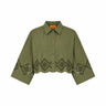 An olive green cropped button-up shirt with a pointed collar and a geometric diamond pattern of cutout eyelet details along the lower front and sleeves, displayed on a solid white background.