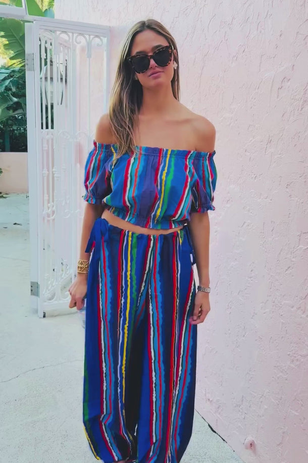 Video of a woman in a multicolored cropped top and bubble pant. 